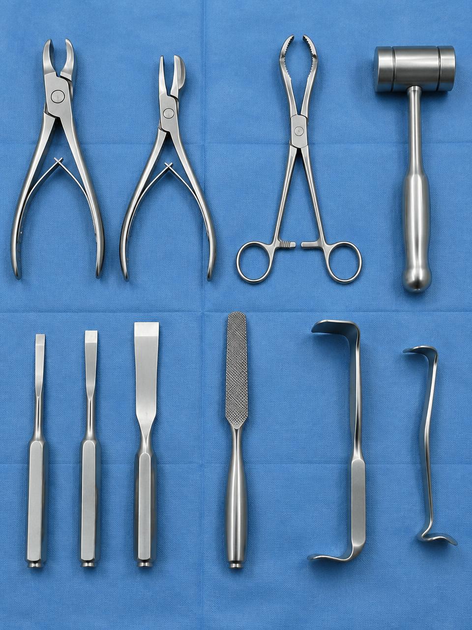 Reusable orthopedic instruments — rongeurs, forceps, osteotomes, mallet, rasp and retractors — on a blue drape